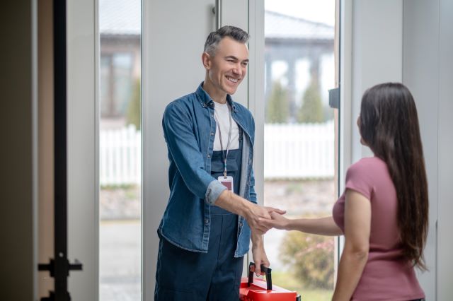 waist-up-man-and-woman-shaking-hands-standing-indoors.jpg