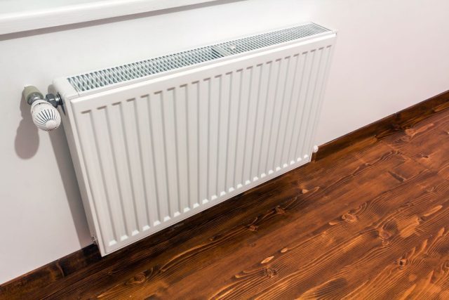 a-white-heating-radiator-on-the-interior-wall