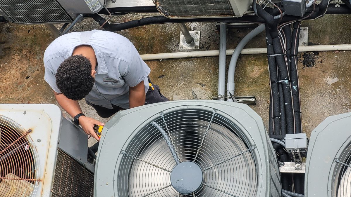 young-hvac-technician-working-on-ac-unit